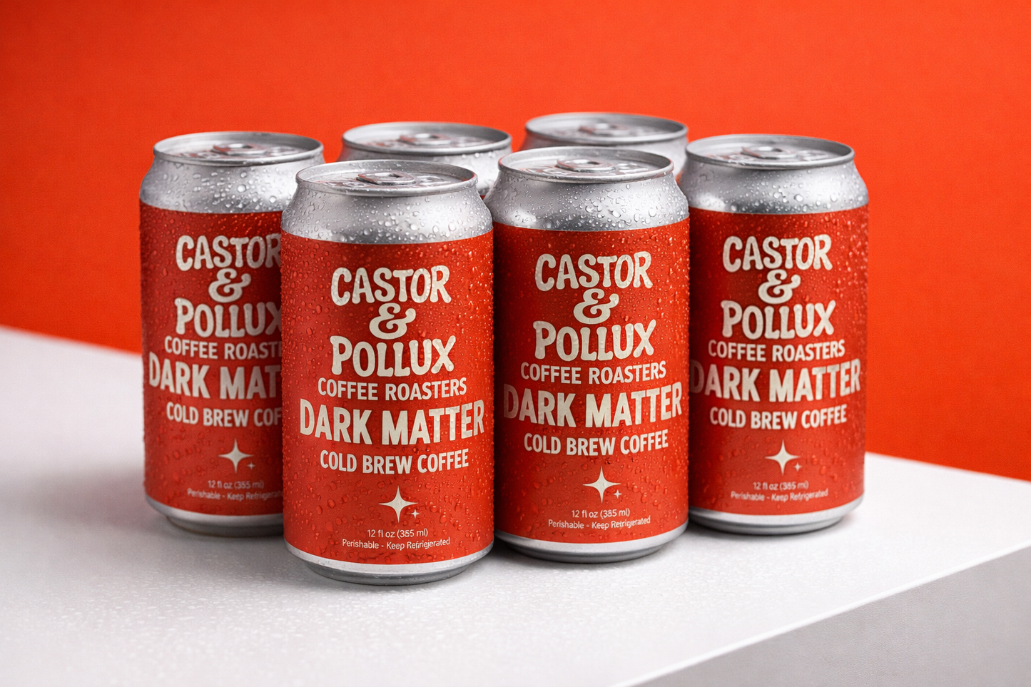 Six cans of Castor & Pollux Dark Matter Cold Brew Coffee against an orange background
