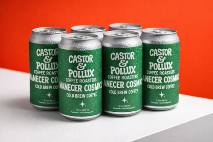 Six cans of Castor & Pollux cold brew coffee on a white surface with an orange background